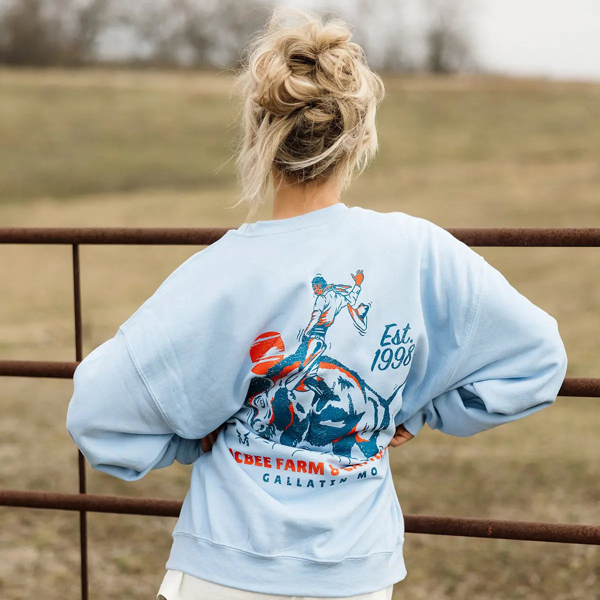 Guy on a Buffalo Crewneck McBee Farm & Cattle Co